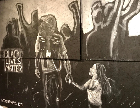 Marching Together Mural - man at protest holds little girls hand