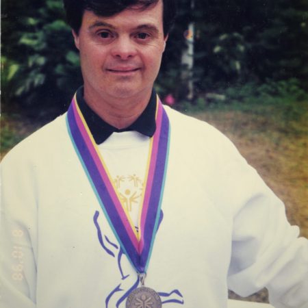 Special Olympian Marty Sheets poses with gold medal